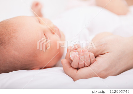 Newborn Baby Asleep Holding Mother 112995743