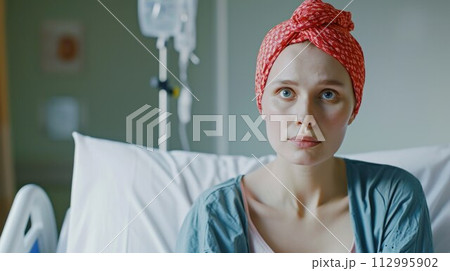 Young cancer woman lying in hospital bed 112995902