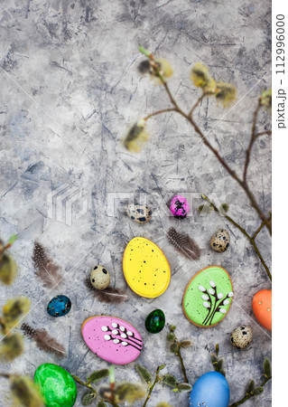 Delicious Easter cookies and painted eggs on gray background, top view Delicious Easter cookies and painted eggs on gray background, top view 112996000