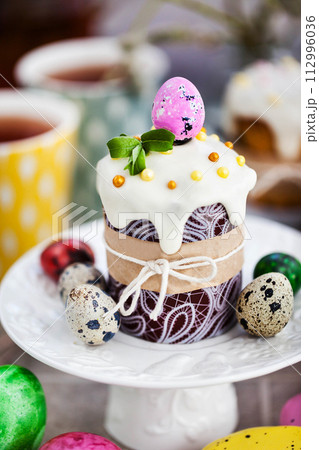 Sweet Easter bread, panettone or kulich and colorful painted eggs, Holiday spring concept 112996036