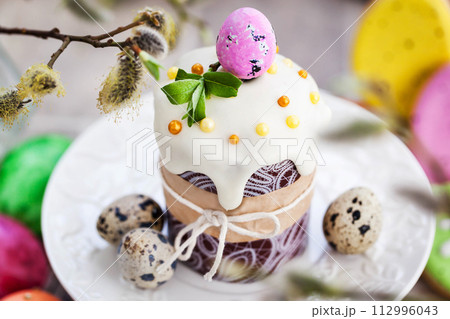 Sweet Easter bread, panettone or kulich and colorful painted eggs, Holiday spring concept 112996043