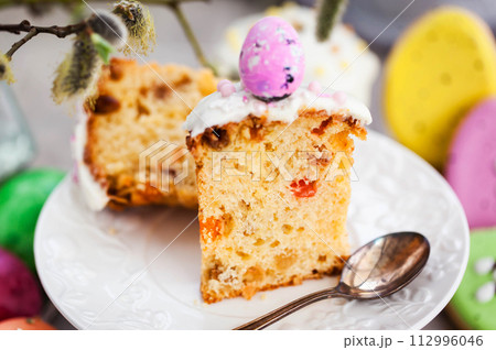 Sweet Easter bread, panettone or kulich and colorful painted eggs, Holiday spring concept Sweet Easter bread, panettone or kulich and colorful painted eggs, Holiday spring concept 112996046
