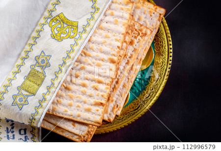 Passover celebration matzah unleavened bread centerpiece on Jewish holiday table Passover celebration matzah unleavened bread centerpiece on Jewish holiday table 112996579
