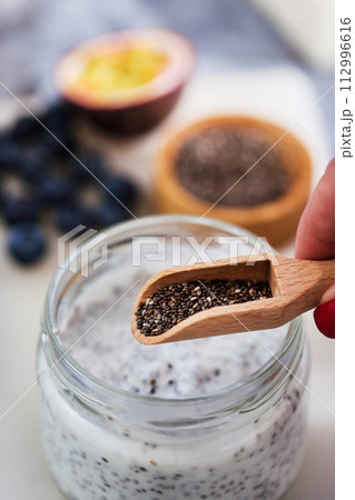 Chia pudding with  yogurt, mango and passion fruit, making process 112996616