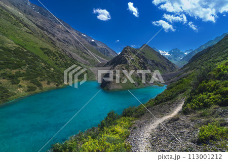 Lake with blue clear clear water in mountains in summer. Koksai Ainakol Lake in Tien Shan Mountains in Asia in Kazakhstan 113001212