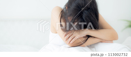 Young asian woman is depression and having mental problem sitting on bed in the bedroom. Young asian woman is depression and having mental problem sitting on bed in the bedroom. 113002732