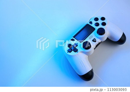 Gamepad on abstract background with light effects Gamepad on abstract background with light effects 113003093