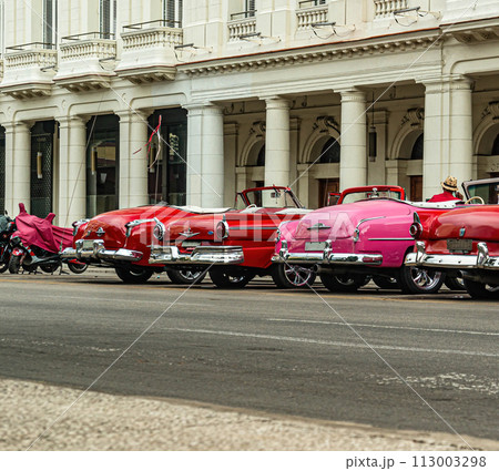 Bright retro cars on Havana street near the hotel. 113003298