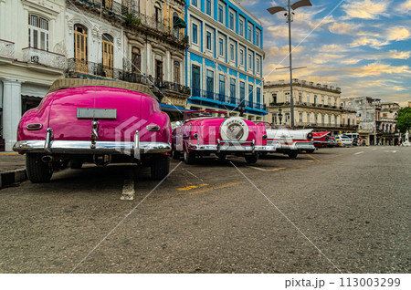 Bright retro cars on Havana street near the hotel. Cuba. Gran Teatro de La Habana, Low angle. 113003299