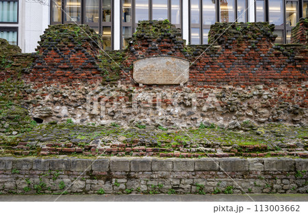London, UK: Part of the ancient city wall of London. This is a medieval wall with the Roman fort wall at its base and topped with a brick parapet added in 1477. Landscape orientation. London, UK: Part of the ancient city wall of London. This is a medieval wall with the Roman fort wall at its base and topped with a brick parapet added in 1477. Landscape orientation. 113003662