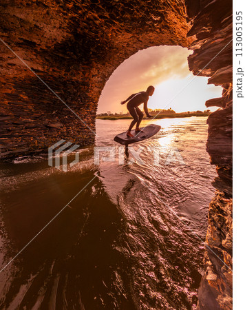 Hydrofoil rider gliding over the water Hydrofoil rider gliding over the water 113005195