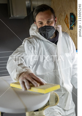 Shaper working on surf board 113005240