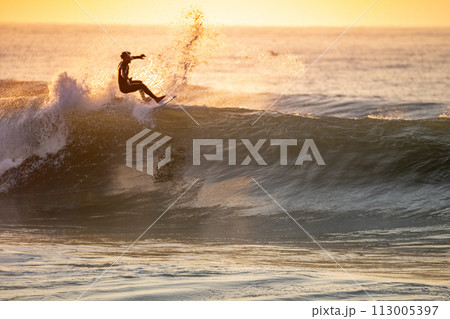 Young surfer enjoying waves Young surfer enjoying waves 113005397