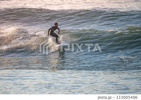 Young surfer enjoying waves 113005486