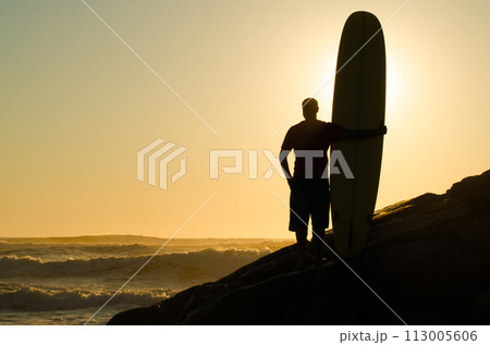 Long boarder watching the waves 113005606