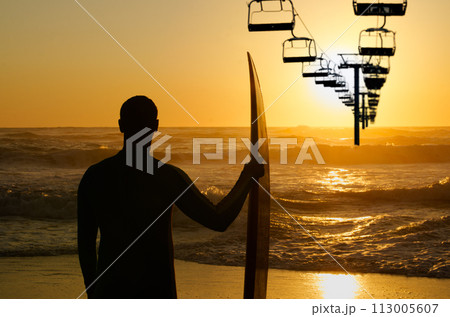 Surfer watching the waves Surfer watching the waves 113005607