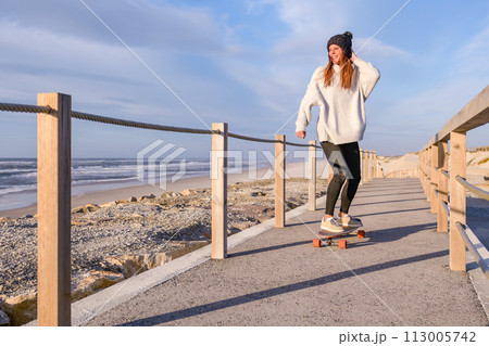 Girl riding a skateboard Girl riding a skateboard 113005742