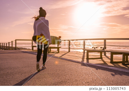 Girl holding a skateboard Girl holding a skateboard 113005743