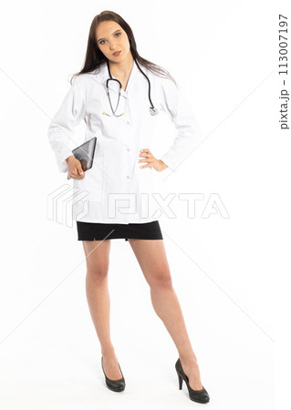 A doctor with a tablet in hand and a stethoscope on her neck wearing a white hospital apron checks the test results. A doctor with a tablet in hand and a stethoscope on her neck wearing a white hospital apron checks the test results. 113007197