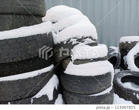 Tires covered with snow at a tire store, closeup of photo Tires covered with snow at a tire store, closeup of photo 113007855