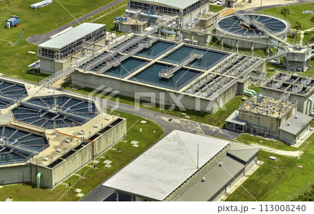 Aerial view of modern water cleaning facility at urban wastewater treatment plant. Purification process of removing undesirable chemicals, suspended solids and gases from contaminated liquid 113008240