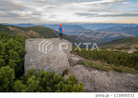 Young child boy hiker standing in mountains enjoying view of amazing mountain landscape. Young child boy hiker standing in mountains enjoying view of amazing mountain landscape. 113008531