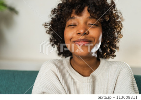 Beautiful African American girl with afro hairstyle smiling. Close up portrait of young happy black girl. Young African woman with curly hair laughing. Freedom happiness carefree happy people concept Beautiful African American girl with afro hairstyle smiling. Close up portrait of young happy black girl. Young African woman with curly hair laughing. Freedom happiness carefree happy people concept 113008811