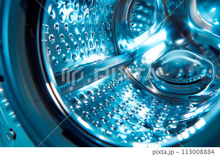 This closeup view shows the inner workings of a washing machine in action. The agitator is moving back and forth This closeup view shows the inner workings of a washing machine in action. The agitator is moving back and forth 113008884