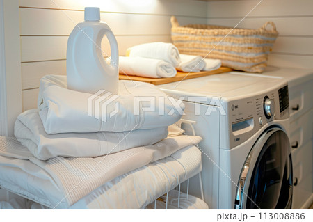 Stack of clean towels on modern washing machine with blurred background. The towels showcasing their soft and fluffy textures 113008886