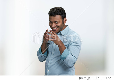 Cunning young man wearing blue shirt thinking about the adventure. Handsome cunning man having a plan. Cunning young man wearing blue shirt thinking about the adventure. Handsome cunning man having a plan. 113009522