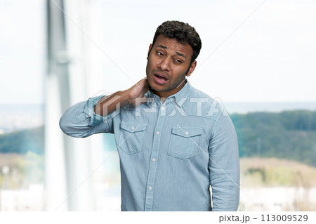 Unhealthy indian man suffering from neck pain. Health problem concept. 113009529