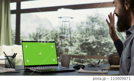 Rich businessman looks at greenscreen on pc, being cozy in his luxurious villa in the woods. Shareholder of multinational company logs onto laptop with isolated chromakey, billionaire lifestyle. Rich businessman looks at greenscreen on pc, being cozy in his luxurious villa in the woods. Shareholder of multinational company logs onto laptop with isolated chromakey, billionaire lifestyle. 113009871