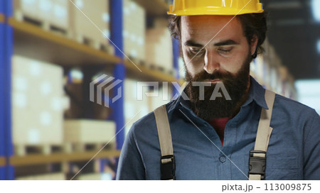 Export manager counts merchandise stock pallets in warehouse, working on storing physical inventory for sale or distribution. Storehouse depot worker checks labels on packages. 113009875