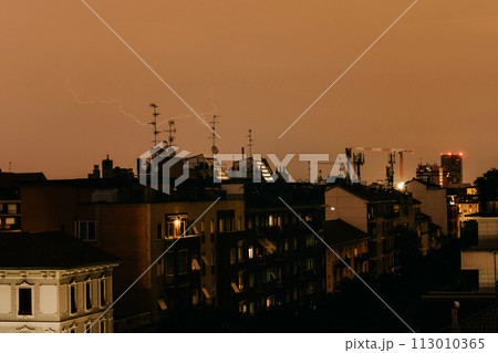 Night city view from window, thunderstorm in town, urban landscape 113010365