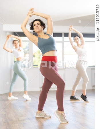 Emotional young Latina practicing flamenco in choreography studio 113015739