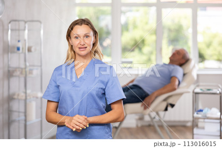 Confident professional female doctor standing in medical office 113016015