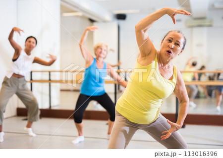 Old lady dancing in studio with women Old lady dancing in studio with women 113016396