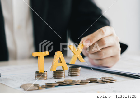 Businessman's hands calculating numbers at a calculator.Tax deduction planning concept. Businessman's hands calculating numbers at a calculator.Tax deduction planning concept. 113018529