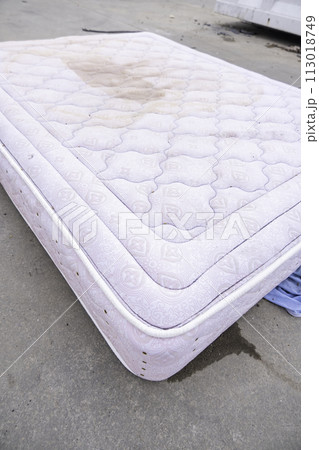 Detail of old damaged mattress thrown into the trash, recycling Detail of old damaged mattress thrown into the trash, recycling 113018749