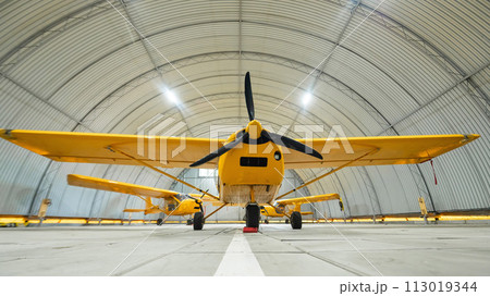 Yellow airplane glider in the hangar. Yellow airplane glider in the hangar. 113019344