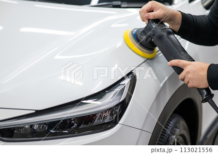 Process of polishing white car hood surface using orbital polishing machine. Process of polishing white car hood surface using orbital polishing machine. 113021556