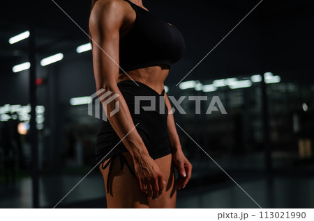 Faceless woman doing vacuum exercise in the gym. Faceless woman doing vacuum exercise in the gym. 113021990