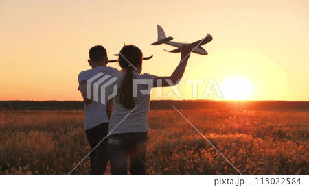 child airplane, children dream airplane pilot, child kid boy girl running with toy airplane across field, working team pilots, silhouette happy children running with toy airplanes hands, happy boy 113022584