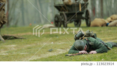 Re-enactor Dressed As German Wehrmacht Soldier Lies Slain In Reconstruction Of Battles World War Ii. German Soldier Uniform. German Infantry Soldier In World War Ii. Win Of Soviet Army In War 113023914