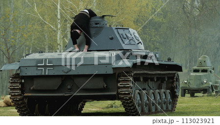 After Battle. Re-enactor Dressed As Dead German Tank Crew Lies Slain On German Wehrmacht Light Panzer Tank In Reconstruction Of Battles World War Ii 113023921