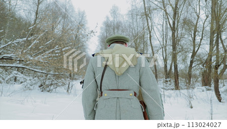 Historical Reenactment of Civil War. Men Dressed As White Guard Soldiers Of Imperial Russian Army In Russian Civil War s Marching Through Snowy Winter Forest 113024027