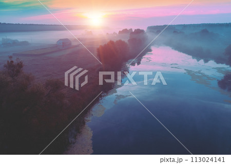 Rural landscape in the morning with the blue-pink sky. Aerial view of the countryside during sunrise 113024141