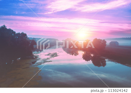 Rural landscape in the morning with the blue-pink sky. Aerial view of the countryside during sunrise 113024142