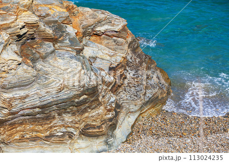Seascape on a sunny day. Rocky sea coast on the Beach Playa de Las Catedrales in Ribadeo, Galicia, Spain, Europe Seascape on a sunny day. Rocky sea coast on the Beach Playa de Las Catedrales in Ribadeo, Galicia, Spain, Europe 113024235