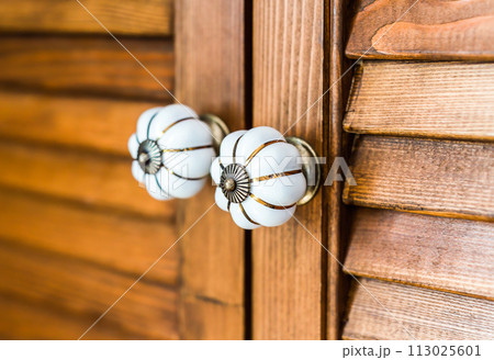 two wooden door handles close up 113025601